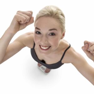 happy woman shoot from above of woman standing on scales